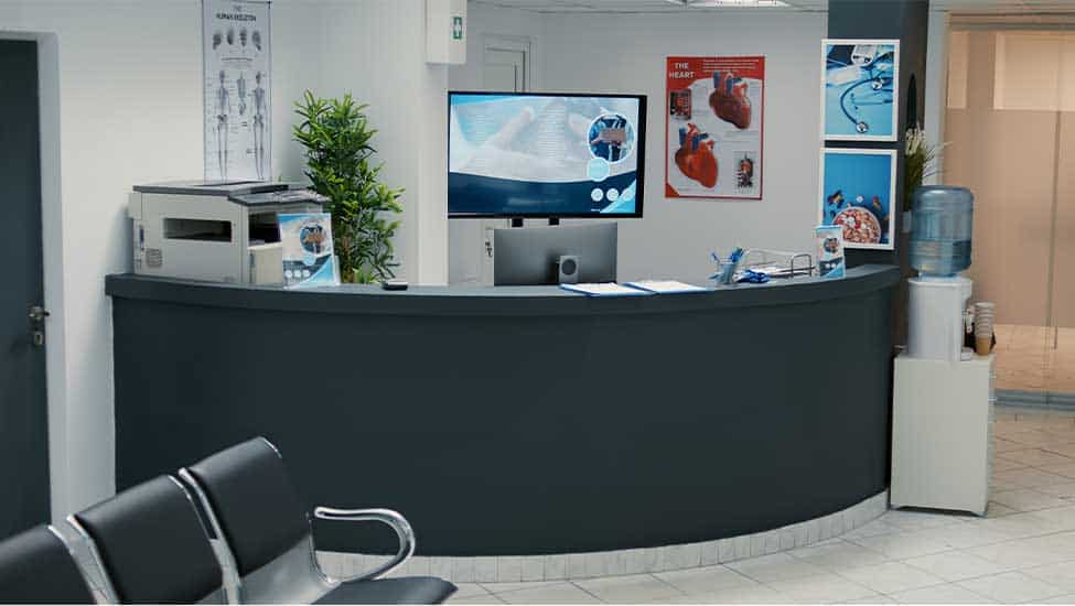 A clinic reception desk with waiting-room seating, serving staff and patients through shifts that run outside cafeteria hours