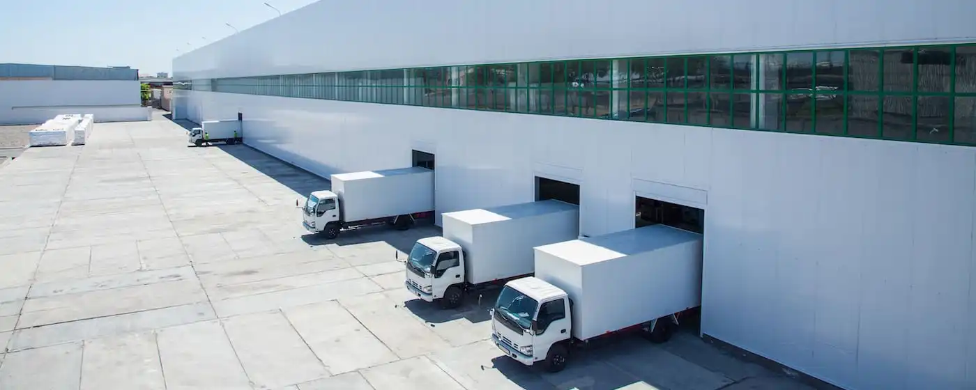 Box trucks backed into the loading docks of a distribution centre